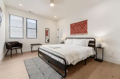 a bedroom with a large bed and a chair at Luxury Escape 4BR 3 bath Oasis in Historic Old Town in Columbus