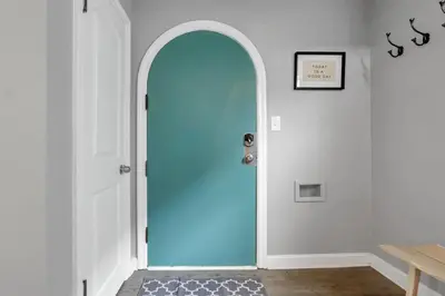 a blue door in a room with a table at The Huron Charmer-4 BD and Yard in Columbus