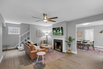 a living room with a couch and a fireplace at The Huron Charmer-4 BD and Yard in Columbus