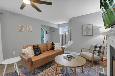 a living room with a couch and a table at The Huron Charmer-4 BD and Yard in Columbus