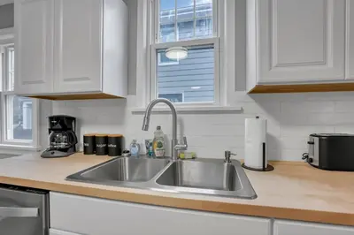 a kitchen counter with a sink and a window at The Huron Charmer-4 BD and Yard in Columbus