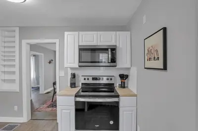 a kitchen with a stove and a microwave at The Huron Charmer-4 BD and Yard in Columbus