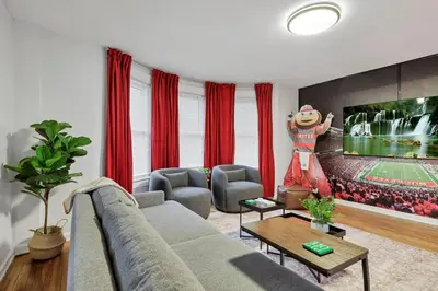 a living room with a couch and a tv at The Ohio State of Mind 5BR 2BA in Columbus