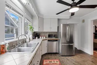 a kitchen with a sink and a ceiling fan at The Ohio State of Mind 5BR 2BA in Columbus