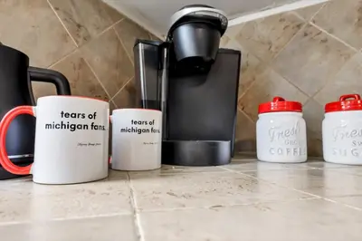 a group of coffee mugs sitting on a counter at The Ohio State of Mind 5BR 2BA in Columbus