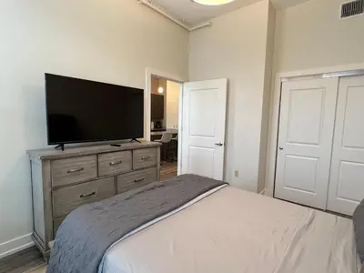 a bedroom with a bed and a flat screen tv at Strongback Suite 205 in Adrian