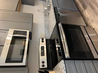 a kitchen with a stove and a microwave at Strongback Suite 205 in Adrian