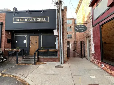 a building with a sign that reads hodgins grill at Strongback Suite 205 in Adrian