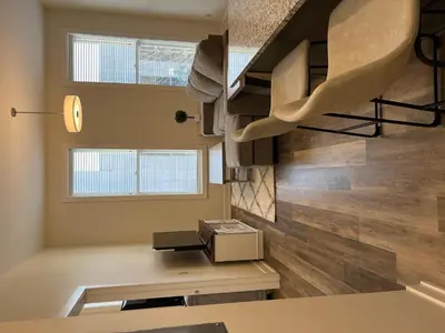 a room with a spiral staircase in a house at Strongback Suite 205 in Adrian