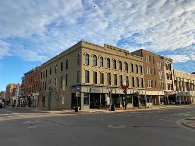 a large building on the corner of a city street at Strongback Suite 207 in Adrian