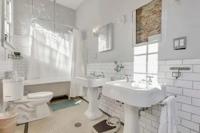 a white bathroom with a sink and a toilet at The Retro Getaway in Columbus