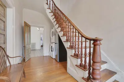 a staircase in a home with a wooden stair case at The Retro Getaway in Columbus