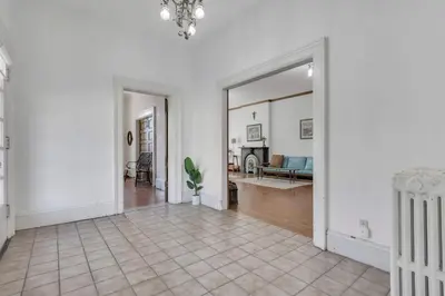 an empty hallway with a living room and a mirror at The Retro Getaway in Columbus