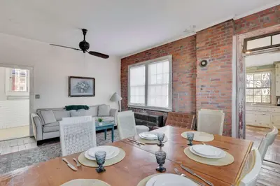 a living room with a wooden table and chairs at The Retro Getaway in Columbus
