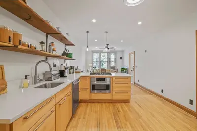 a large kitchen with wooden cabinets and a sink at The Urban Oasis - 2 BR - Great Location in Columbus