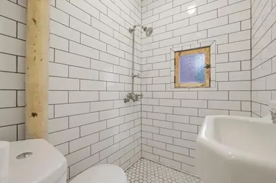 a white bathroom with a toilet and a sink at The Urban Oasis - 2 BR - Great Location in Columbus