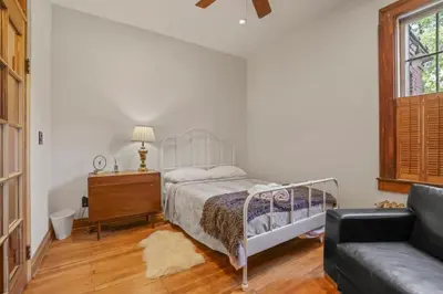 a bedroom with a bed and a dresser and a couch at The Urban Oasis - 2 BR - Great Location in Columbus