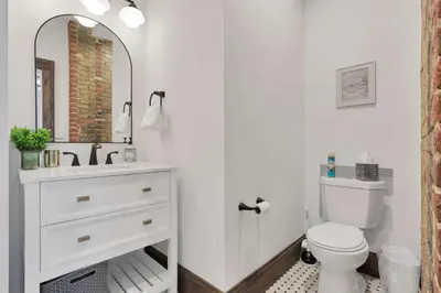 a bathroom with a toilet and a sink and a mirror at The Urban Oasis - 2 BR - Great Location in Columbus