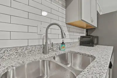 a kitchen counter with a sink and a microwave at Bright and Breezy Gahanna Ranch 10min to INTEL in Columbus