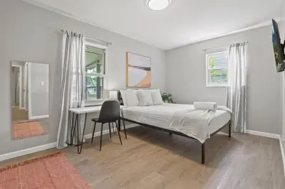 a bedroom with a bed and a desk in it at Bright and Breezy Gahanna Ranch 10min to INTEL in Columbus
