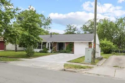 a home on the corner of a street at Bright and Breezy Gahanna Ranch 10min to INTEL in Columbus