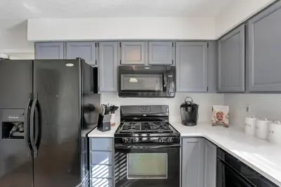 a kitchen with a stove and a refrigerator at Gahanna Dreaming - 5Br 2 Ba INTEL in Gahanna