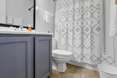 a bathroom with a toilet and a shower curtain at Gahanna Dreaming - 5Br 2 Ba INTEL in Gahanna