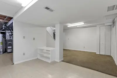 an empty garage with white walls and a staircase at Gahanna Dreaming - 5Br 2 Ba INTEL in Gahanna