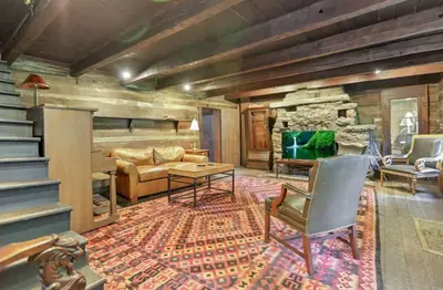 a living room with a couch and a table at The City Cabin - Unique and Historic in Columbus