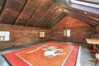 an attic room with a rug on the floor at The City Cabin - Unique and Historic in Columbus