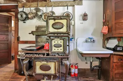 a kitchen with an old stove and a sink at The City Cabin - Unique and Historic in Columbus