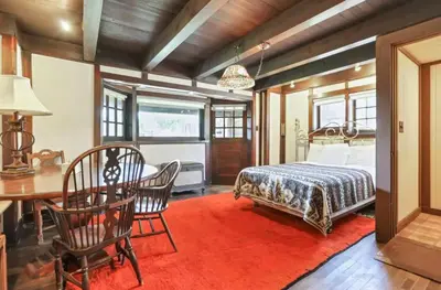 a bedroom with a bed and a table and chairs at The City Cabin - Unique and Historic in Columbus