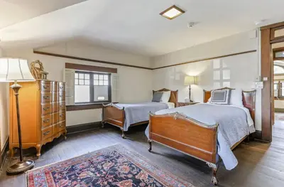 a bedroom with two beds and a dresser at The City Cabin - Unique and Historic in Columbus