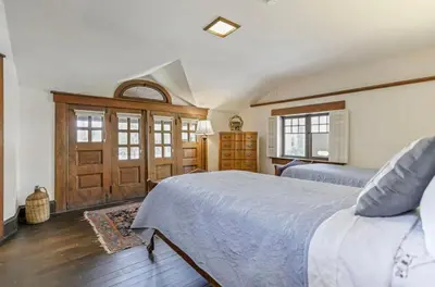 a bedroom with a bed and a wooden door at The City Cabin - Unique and Historic in Columbus