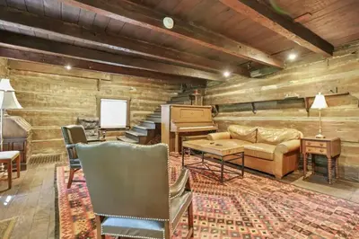 a living room with a couch and a piano at The City Cabin - Unique and Historic in Columbus