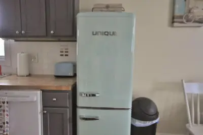 a kitchen with an old refrigerator in a kitchen at The City Cottage - Unique and Cozy in Columbus