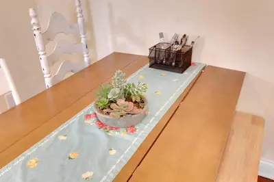 a table with a potted plant on top of it at The City Cottage - Unique and Cozy in Columbus