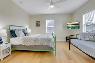 a bedroom with a bed and a couch at The City Cottage - Unique and Cozy in Columbus