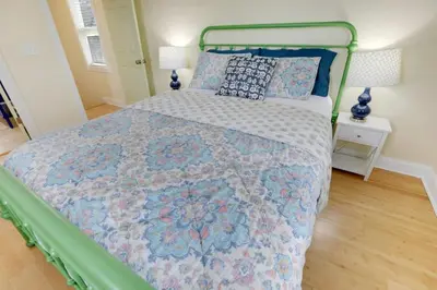 a bedroom with a bed with a quilt on it at The City Cottage - Unique and Cozy in Columbus