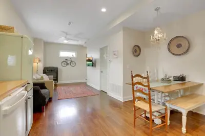 a kitchen and living room with a table and a chair at The City Cottage - Unique and Cozy in Columbus