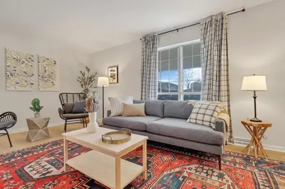 a living room with a couch and a table at Gahanna Farmhouse - 4 Bed 2 Bath - INTEL in Columbus