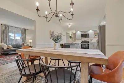 a dining room and living room with a table and chairs at Gahanna Farmhouse - 4 Bed 2 Bath - INTEL in Columbus