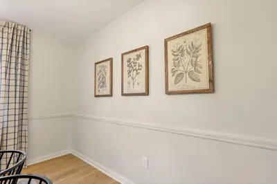 three framed paintings on a white wall in a room at Gahanna Farmhouse - 4 Bed 2 Bath - INTEL in Columbus
