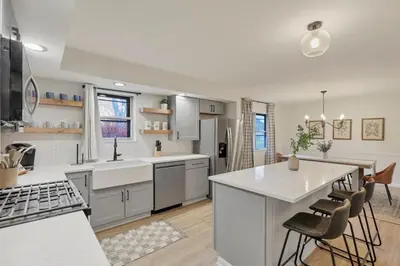 a kitchen with white cabinets and a kitchen island at Gahanna Farmhouse - 4 Bed 2 Bath - INTEL in Columbus