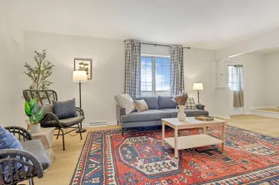 a living room with a blue couch and a rug at Gahanna Farmhouse - 4 Bed 2 Bath - INTEL in Columbus