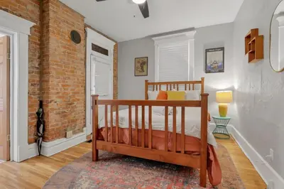 a bedroom with a bed and a brick wall at The Goodale Retreat - 2 BR 2Bath in Columbus