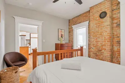 a bedroom with a bed and a brick wall at The Goodale Retreat - 2 BR 2Bath in Columbus