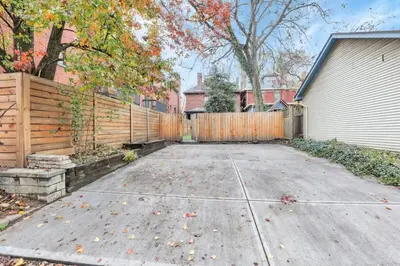 a driveway with a fence next to a house at The Goodale Retreat - 2 BR 2Bath in Columbus