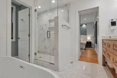 a bathroom with a shower and a bath tub at The Mohawk Masterpiece in Columbus