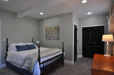 a bedroom with a bed with blue pillows and a table at Breath of Fresh Air - House- 3 BR 2BA in Columbus